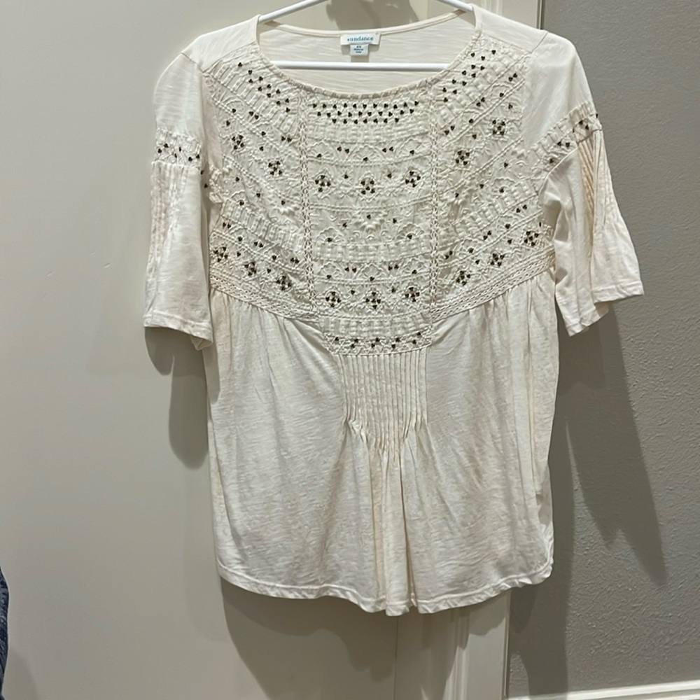Cream blouse with copper beads on it